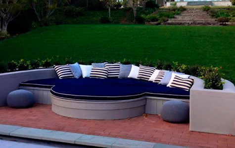 pool-side seat with blue cushions