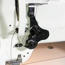 tension wheels holding thread securely